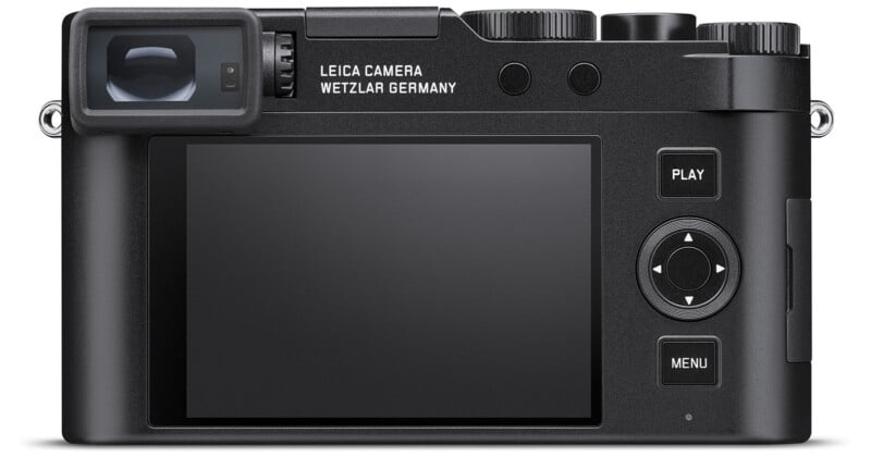 The back view of a black Leica camera featuring a large LCD screen, various buttons including "Play" and "Menu," and a viewfinder. Text on the camera says "Leica Camera Wetzlar Germany." The camera is against a white background.