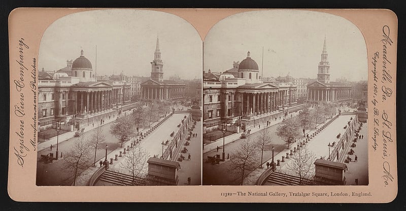 Stereoscopic image showing The National Gallery in Trafalgar Square, London, England. The scene captures a bustling street with people and horse-drawn carriages, surveying a panorama that includes notable buildings and the equestrian statue of Charles I.