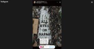 An aerial view of a large crowed surrounding multiple stretchers covered with white shrouds. Text overlay reads, "ALL EYES ON RAFAH. We all shared the AI image. Now let's share the real image." An Instagram sticker with "Add yours" is at the bottom.