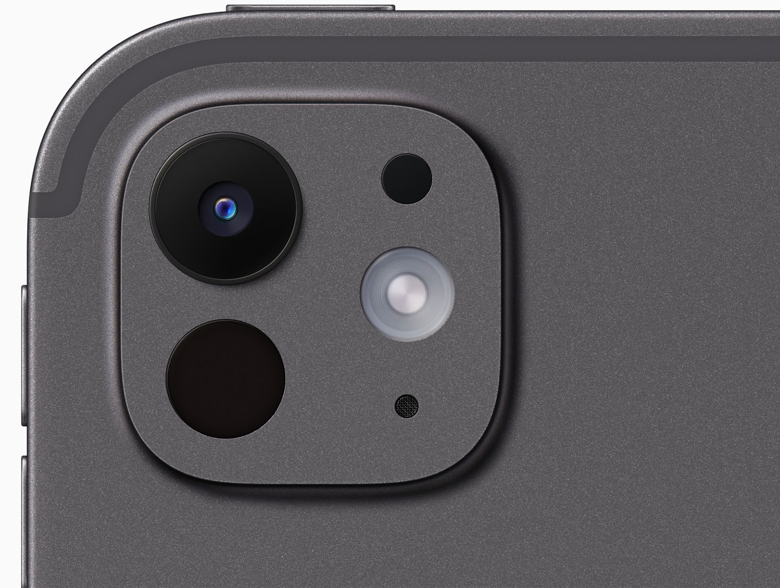 Close-up of a smartphone's dual-camera system on a dark gray metallic surface, showing two lenses, an led flash, and a microphone hole.
