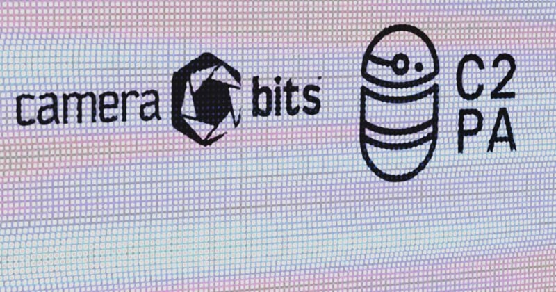 A digital screen displays logos, including the Camera Bits logo with a stylized camera aperture icon, and the C2PA logo featuring a circular design with horizontal lines and a dot. The words "camera bits" and "C2PA" are written next to their respective logos.