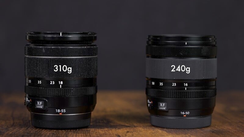 Two camera lenses are placed side by side on a wooden surface. The lens on the left is labeled "310g" and marked with 18-55mm focal length. The lens on the right is labeled "240g" and marked with 16-50mm focal length. Both lenses have a black and gray design.