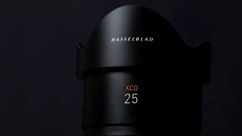 Close-up of a hasselblad xcd 25 camera lens hood against a dark background, highlighting the brand name and model in white text.