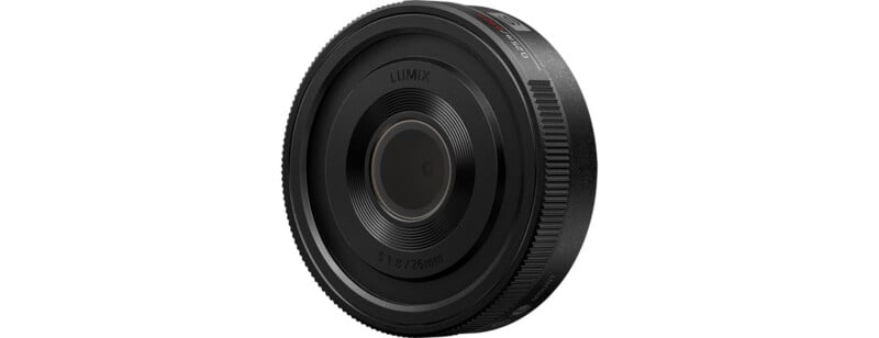 A black Lumix camera lens with a focal length range of 9-18mm and an aperture of f/2.8. The lens features a sleek, compact design with clear markings and a smooth, ribbed grip around the circumference for easy handling.
