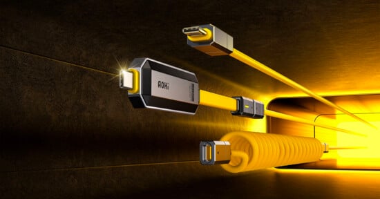 Illustration of various yellow charging cables against a futuristic, illuminated background. The cables are highlighted, converging into a coiled form, with one labeled "AOHi."