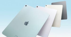 Four iPad Air models in different shades including blue, silver, and grey, are fanned out with their apple logos visible against a soft blue gradient background.