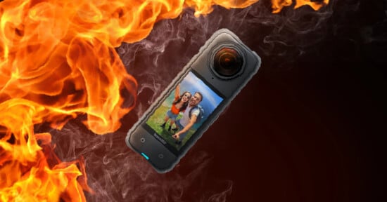 A smartphone displaying a photo of a smiling couple is engulfed in dramatic flames, illustrating a concept of data loss or damage.