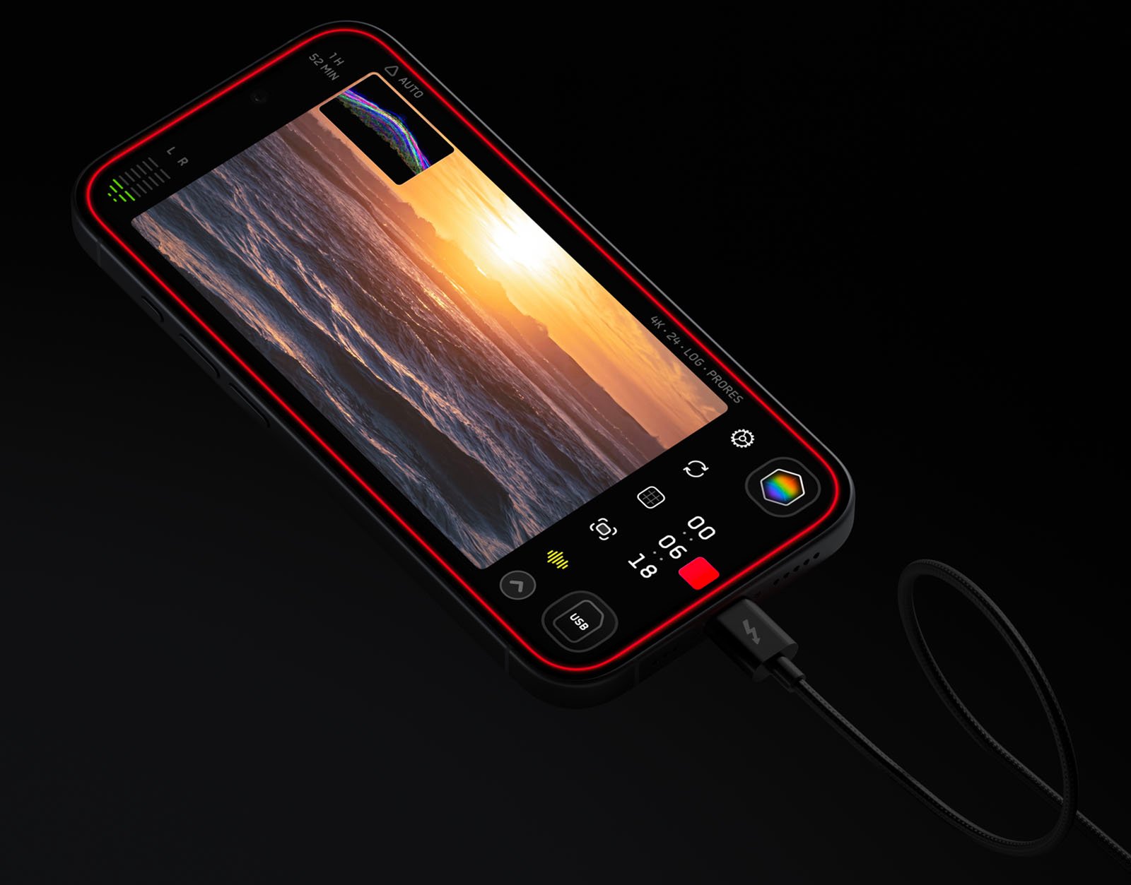 A smartphone displaying a video editing app on its screen lies against a black background. The phone is connected to a cable. The app shows a video clip of a sunset over the ocean, with various editing tools and interface icons visible around the display.