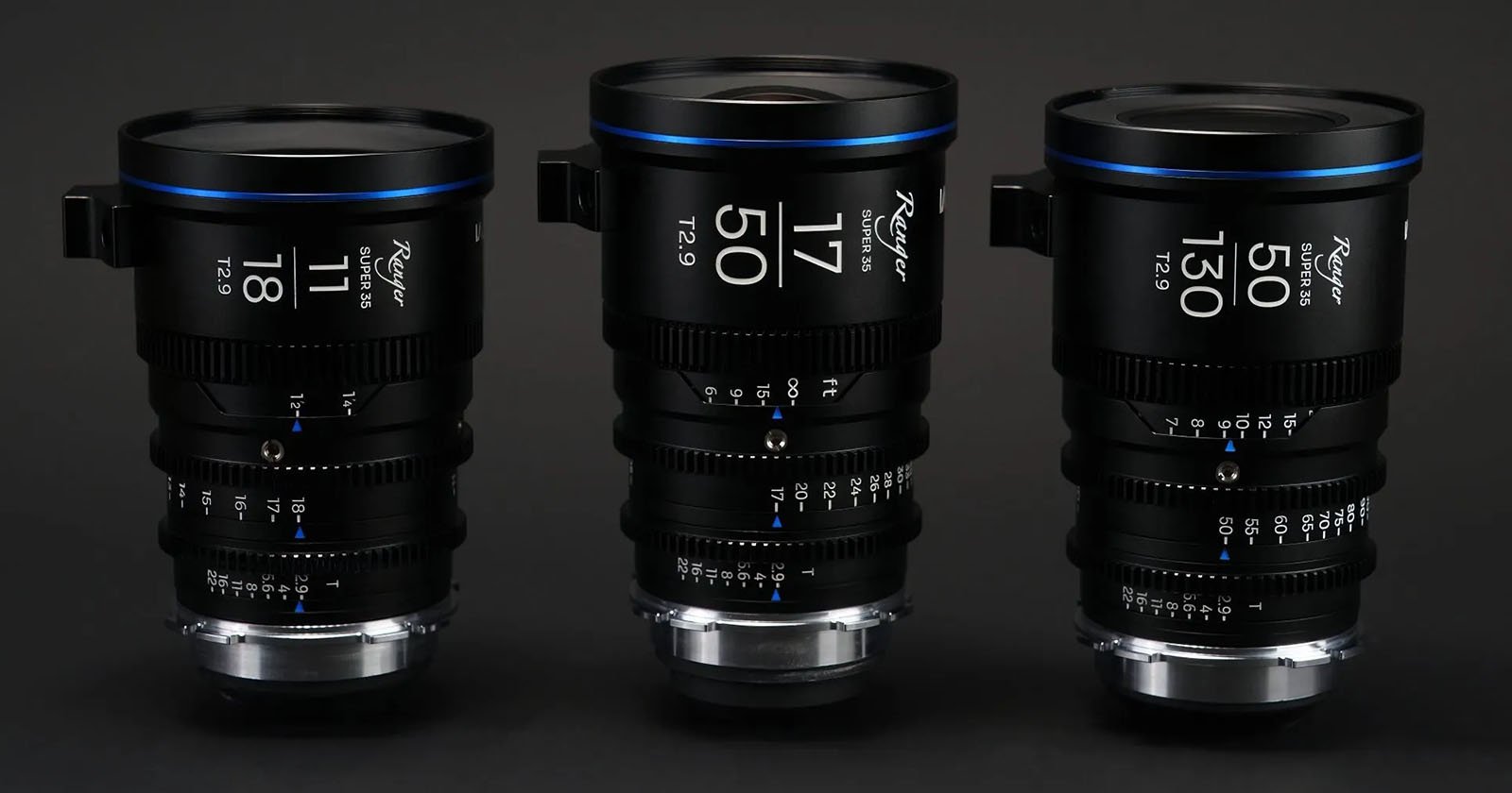 Three professional cinema lenses aligned side by side, with detailed focus and aperture scales visible on a dark background.