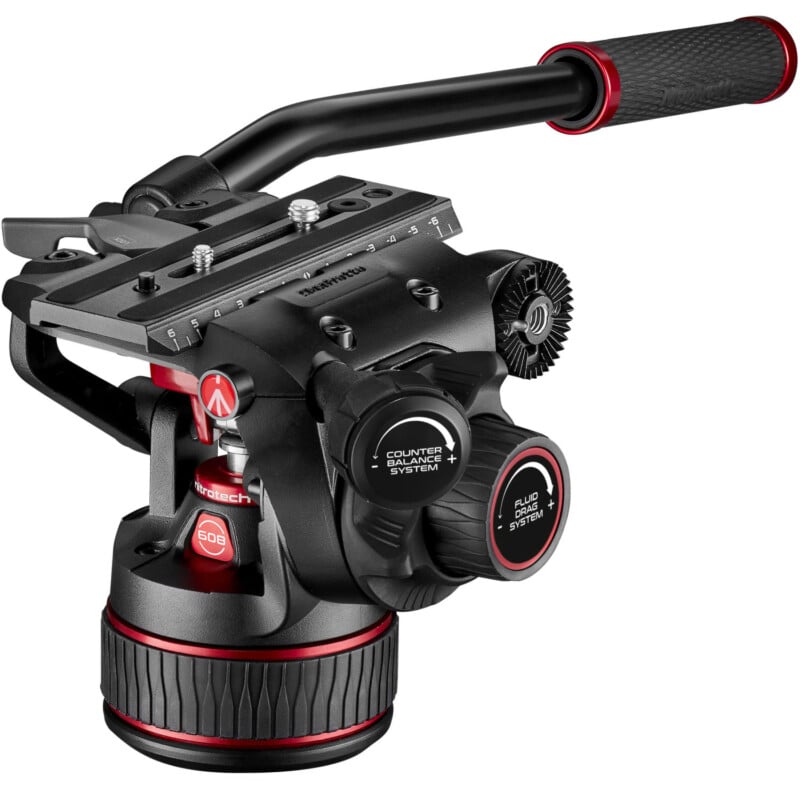 A professional black and red video camera tripod head with multiple adjustment knobs, dials, and a sliding plate, isolated on a white background.