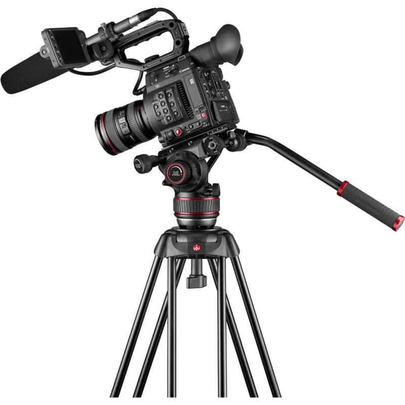 A professional video camera mounted on a tripod with a pan handle. the camera is equipped with multiple adjustment knobs and a viewing screen extended to the side.