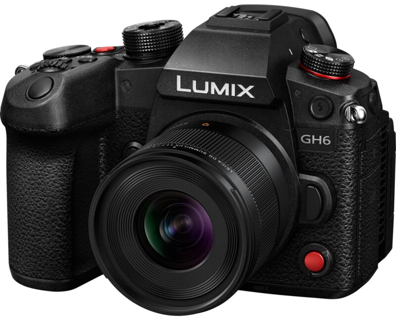 A close-up image of a black panasonic lumix gh6 camera with a prominent lens and detailed control buttons visible on the top and side of the camera body.