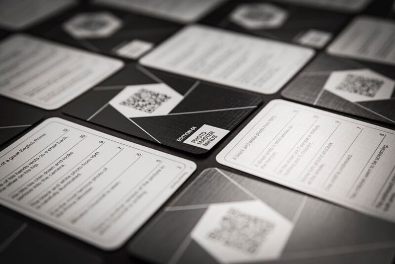 A close-up view of an assortment of cards displayed on a table, featuring various qr codes and text details.