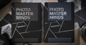 Two boxes labeled "Photo Master Minds Edition 01" and "Edition 02" with geometric designs, lying among various photographic equipment.