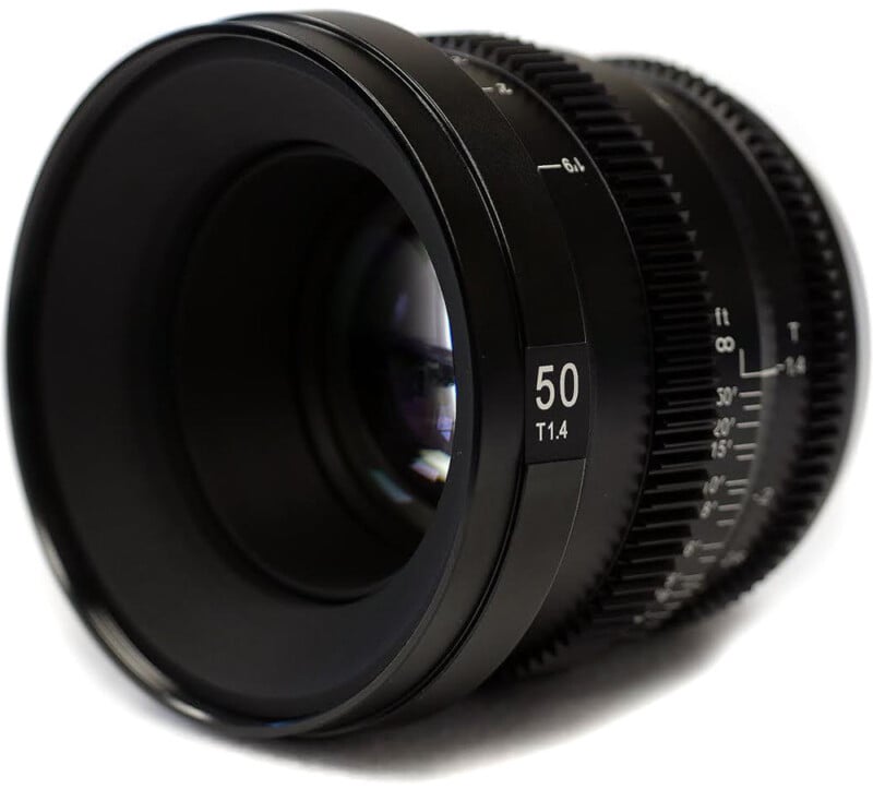 Close-up of a black 50mm f/1.4 camera lens with focus and aperture scales visible, set against a white background.