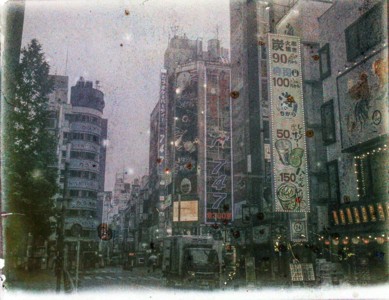 A vintage-effect photo showing a bustling city street with neon signs and advertisements. the image has a grainy, textured overlay adding a nostalgic feel to the urban scene.