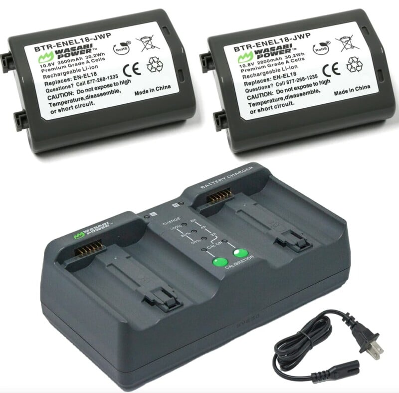 Two identical replacement batteries are displayed above a dual battery charger with an ac power cable. all items are marked with specifications and recycling symbols.