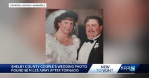 A wedding photo of a couple dressed in formal attire. The bride wears a white gown and veil, while the groom is in a black tuxedo with a white bow tie. The image has a news banner stating the photo was found 90 miles away after a tornado.