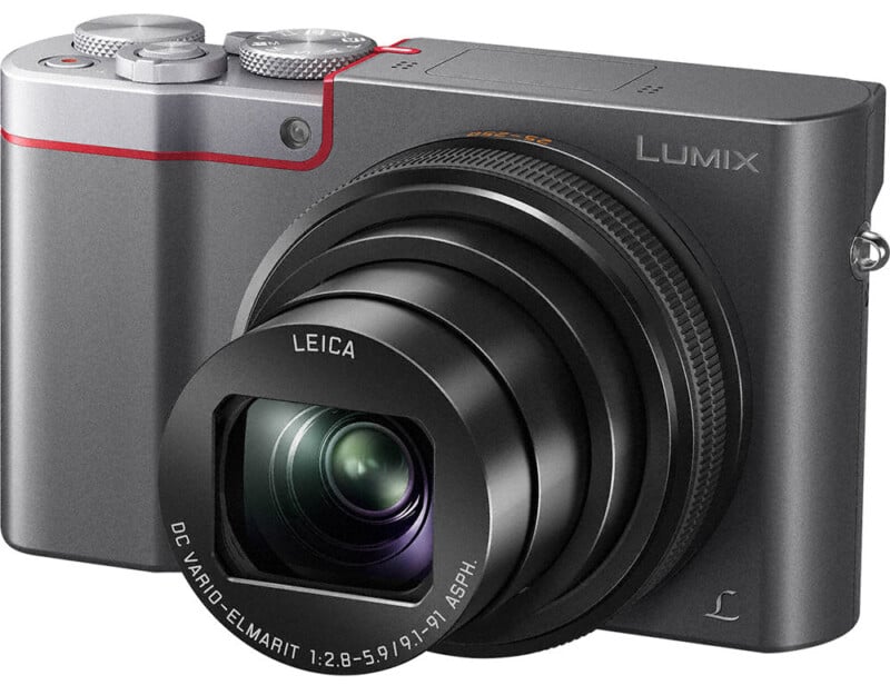A panasonic lumix digital camera with an extended zoom lens and red detailing on a gray body, featuring leica lens technology.