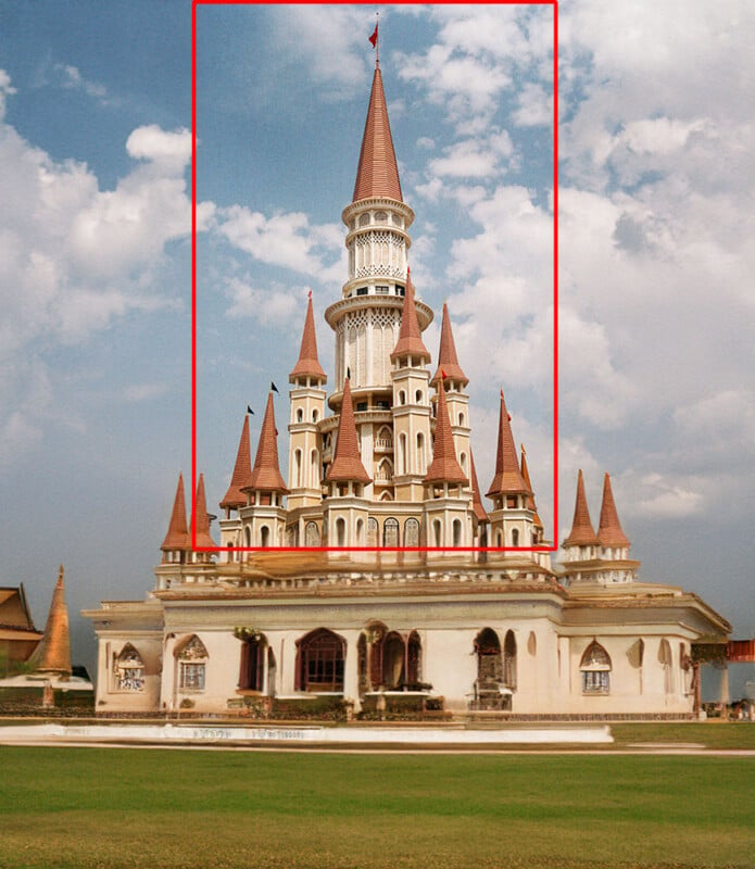 A grand Thai temple with an ornate central spire and four surrounding smaller spires, set against a backdrop of blue sky and clouds. The temple is richly decorated and surrounded by lush green lawns and additional traditional structures.