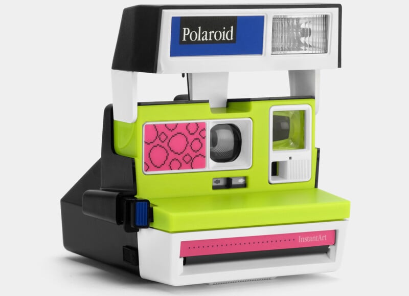 A retro Polaroid instant camera with a neon green and pink front panel, a blue button on the side, and a blue Polaroid label on the flash area. The camera has a distinct vintage design with a pop of vibrant colors. .