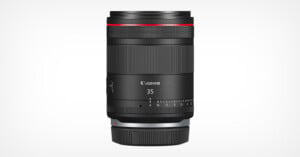 A Canon 35mm camera lens with a sleek black design. The lens features a red ring near the top, a focus adjustment ring, and a control ring. The brand name "Canon" and the number "35" are printed in white on the front. The background is plain white.