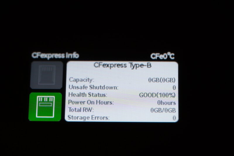 A close-up view of a camera screen displaying CFexpress card information. The screen shows a CFexpress Type-B card with 0GB capacity, 0 unsafe shutdowns, 100% health status, 0 hours of power on time, 0GB total read/write, and 0 storage errors.