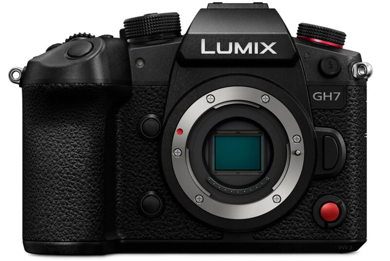 A black Panasonic LUMIX GH7 digital camera with various buttons and dials. The lens is not attached, revealing the sensor inside the camera body. The model name “GH7” is visible on the upper right, and the camera has a textured grip on the left side.