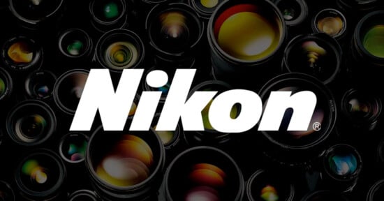 The image features the Nikon logo prominently displayed in bold white letters against a background filled with close-up shots of various camera lenses, highlighting reflections of light on the glass surfaces.