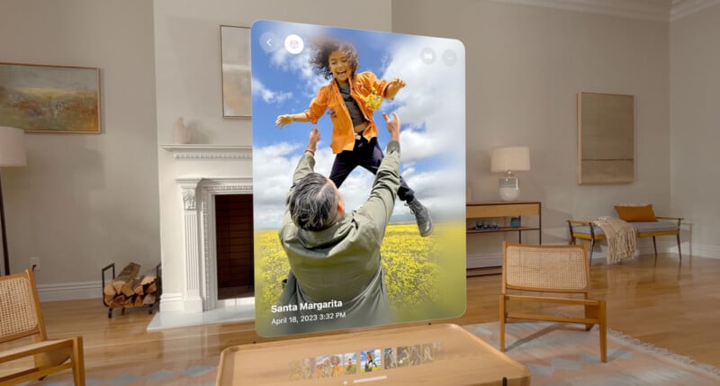 A virtual screen displays a photo of a man lifting a woman into the air, both smiling, in a field of flowers. The screen shows the date "April 18, 2023" and location "Santa Margarita." The scene is set in a modern living room with minimalist decor.