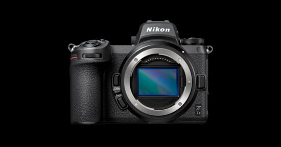 Front view of a Nikon Z 7II mirrorless digital camera without a lens. The camera has a black body, a grip on the left, and various buttons and dials. The Nikon logo is visible at the top, and the Z 7II model name is on the bottom right corner.
