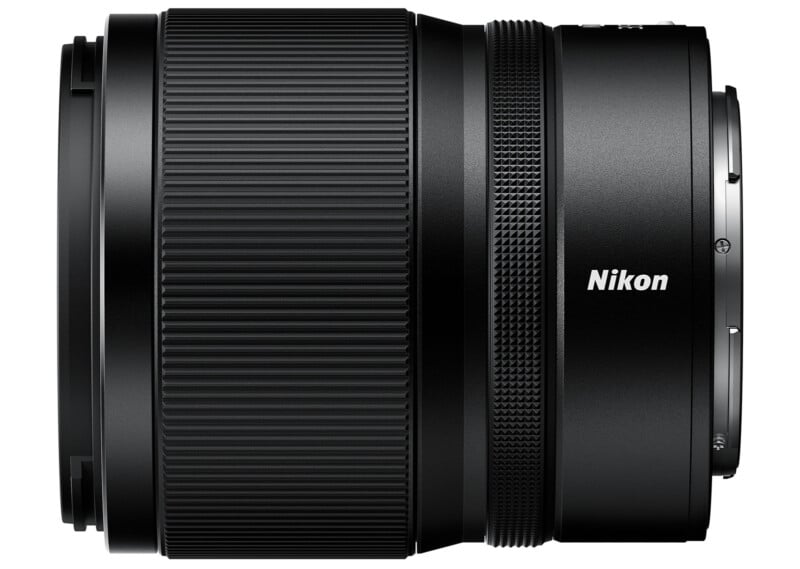 A side view of a Nikon camera lens with a black body. The lens has ridged focus rings and "Nikon" is printed in white text on the side. The overall design is sleek and modern.