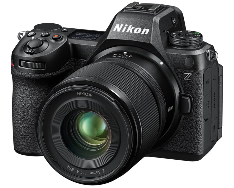 A black Nikon Z mirrorless camera with a large NIKKOR Z lens attached, featuring various buttons and dials on its body and a textured grip for handling. The screen and viewfinder are visible on the back, with the brand's logo clearly displayed on the front and top.