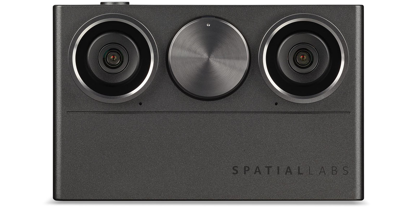 The image shows the front view of a sleek, metallic SpatialLabs device with two prominent camera lenses on each side and a central circular knob or button. The brand name "SPATIALLABS" is visible on the bottom right corner of the device.