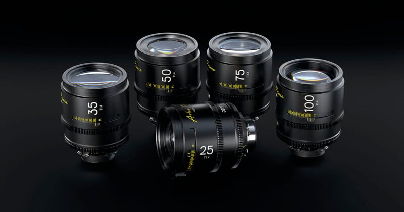 A set of five black camera lenses with different focal lengths (3.5 mm, 5.0 mm, 7.5 mm, 10.0 mm, and 25 mm) are arranged on a black surface. Each lens has white and yellow text inscribed on the body, indicating their specifications and focal lengths.