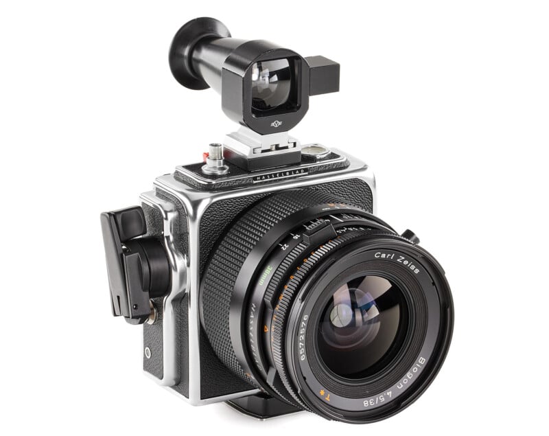 A high-end black and silver medium format camera with a large lens labeled "Carl Zeiss" and "Distagon 4/50." It features a detachable viewfinder mounted on top, and other controls and attachment points are visible on its sleek and robust body.