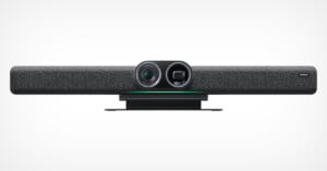 A sleek, modern soundbar-style video conferencing device with a grey fabric front, featuring a camera and sensors in the center. The device is predominantly black with a minimalist design, suitable for mounting under a monitor or on a conference room table.