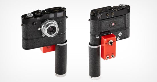 Two classic Leica film cameras mounted on vertical grip attachments. The camera on the left shows the lens and controls from the front view, while the one on the right shows the camera's back view. Both grips feature a red base component with dials and sockets.