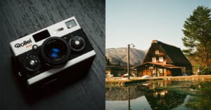 A Rollei 35A camera is placed on a wooden surface on the left, and on the right is a rustic A-frame house with a thatched roof next to a pond, reflecting the house. The scene is set in a mountainous area with clear skies and surrounding trees.