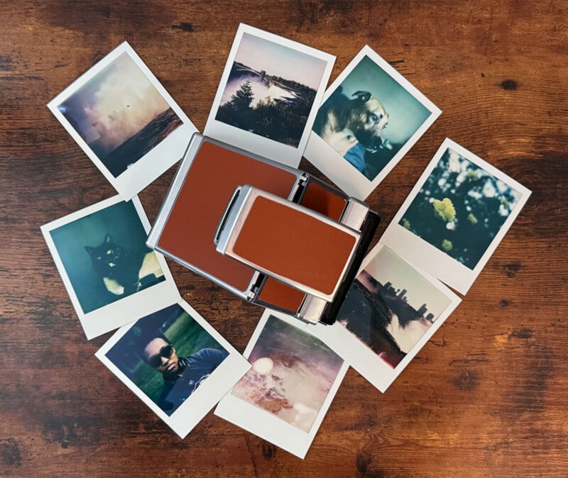 A vintage instant camera lies on a wooden surface, surrounded by nine Polaroid photos. The images include nature scenes, a cat, and a person wearing sunglasses, displaying a nostalgic and eclectic assortment of moments captured on film.