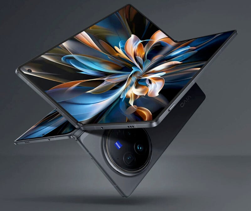 An innovative, foldable smartphone is displayed partially open, revealing an intricate and colorful pattern on its screen. The device has a sleek design with a large, circular camera module on the back. The brand name "Vivo" is visible.