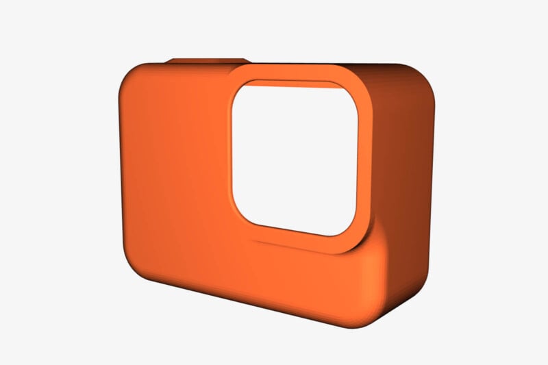 A 3D rendering of a small, rectangular, orange case with rounded corners and an open window in the center. The case appears to be made of plastic and is viewed from an angle showing its thickness and depth. The background is white.