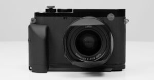 A sleek, black Leica camera is shown facing forward against a plain background. The "Leica" logo is visible on the upper right of the body, and the lens prominently displays text reading "SUMMILUX 1:1.7/28 ASPH." The camera has textured grips and multiple dials.