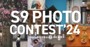 A collage of various photos with centerpiece text reading "S9 PHOTO CONTEST '24" and a subtext "26mmで切り取るあなたの世界." The images depict flowers, a cat statue, abstract art, architectural elements, a bowl of green treats, ceramics, and a hand holding a phone.