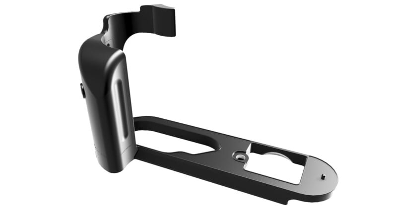 A black L-shaped camera bracket with a vertical grip. The bracket has various cutouts and a mounting hole for attaching to a tripod. The grip is contoured for hand-held comfort and provides additional stability for the camera.