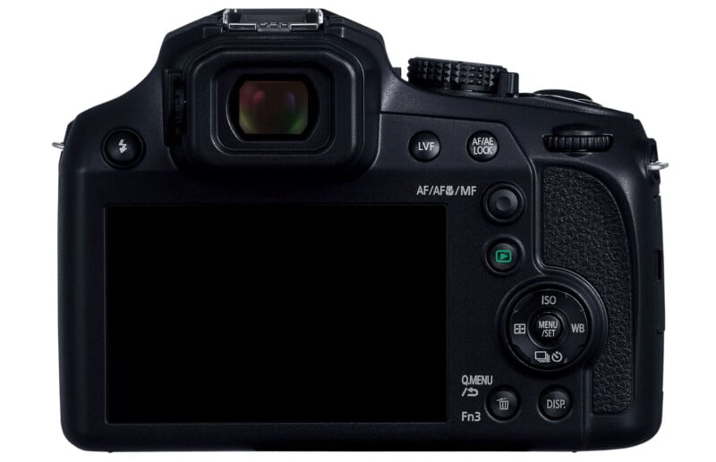 Back view of a black digital camera showcasing its LCD screen, viewfinder, and various control buttons, including ISO, white balance, exposure compensation, AF/AE lock, and function buttons. The camera design includes a textured grip section on the right.