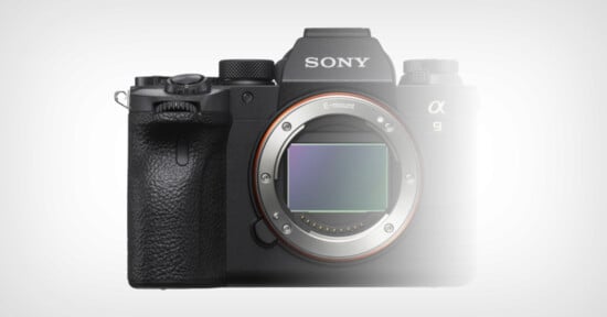 A black Sony Alpha 9 camera with a lens mount visible in the center, showcasing its E-mount. The camera has a textured grip on the left side, and several buttons and dials are present on the top and front. The brand name "Sony" is prominent on the top front.
