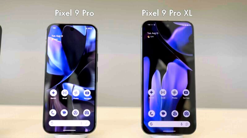 Two smartphones side by side are displayed against a neutral background, with text above them reading "Pixel 9 Pro" for the left phone and "Pixel 9 Pro XL" for the right phone. Both phones show similar home screens with app icons, a clock, and a date.