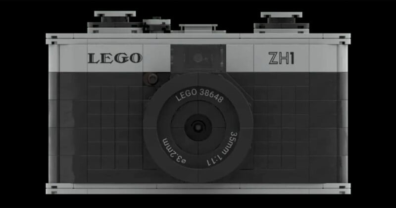 A black and grey LEGO camera model with the label "LEGO ZH1" prominently displayed. The lens has markings indicating "LEGO 38648" and "35mm f1:1." The design mimics a classic camera on a black background.