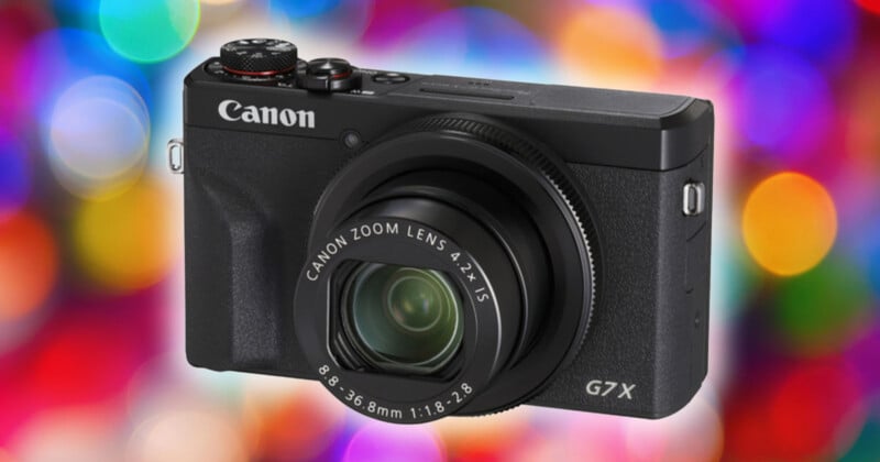 A black Canon G7X camera is centered against a colorful bokeh background. The camera has a protruding lens with text indicating "Canon Zoom Lens 4.2x IS." Multicolored circles of light are scattered in the out-of-focus backdrop.